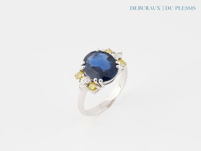 a close up of a ring with a blue stone on it