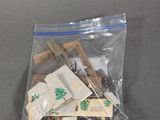 a plastic bag with a bunch of small items inside of it