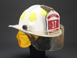 a white fireman ' s helmet with a yellow visor on it
