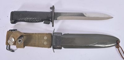 two knives that are laying next to each other on a table