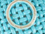 a ring that is sitting on top of a blue basket