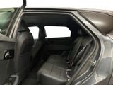 the back seats of a car with the door open and the driver ' s seat down