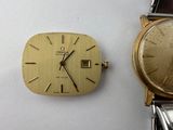 an image of a couple of watches sitting next to each other on a table