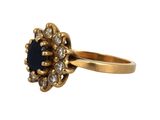 an image of a gold ring with a blue stone surrounded by white diamonds