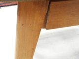 a close up view of a wooden table with a gray cover