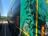 a green semi truck that is parked on the side of the road