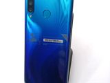 a close up of the back of a blue phone with a sticker on it