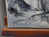 a painting on a wooden easel with a black and white picture