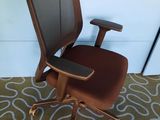 an image of a brown office chair sitting on top of a carpet