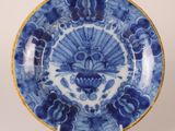a blue and white plate with a fan design on it