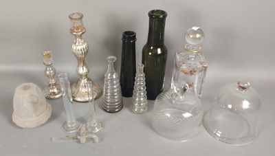 de nombreuses bouteilles et vases en verre posés sur une table