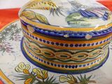 a colorful bowl and plate on a red table cloth