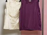 two shirts hanging on a clothes rack in front of a pink and white wall
