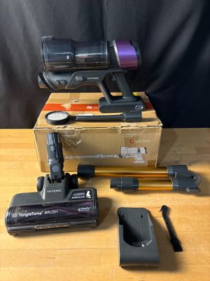 two vacuums are sitting on top of a table next to a box