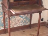 a small desk with a mirror on top of it