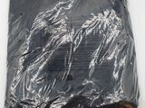 a bag of black plastic material on a white surface