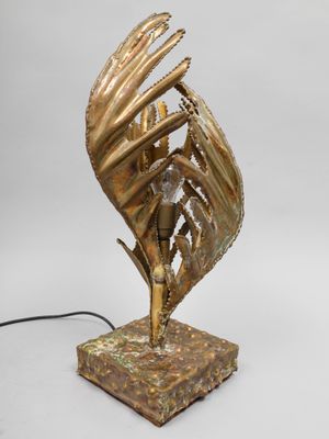 une photo d'une sculpture en bronze représentant un oiseau posé sur un socle en marbre
