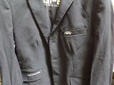 a black jacket hanging on a hanger in a store