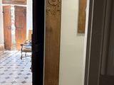 a doorway leading to a room with a chair and a table