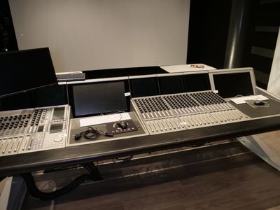 une photo d'une console d'enregistrement avec deux écrans et un ordinateur portable