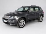 the bmw x5 is parked in a studio with a white background