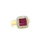 a close up of a gold ring with a ruby stone and diamonds