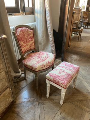 a chair and a foot stool in a room