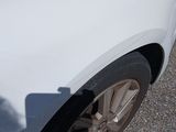 a white car parked on the side of the road