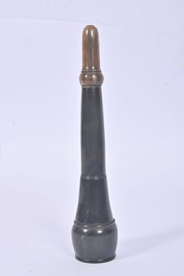 a black and gold vase sitting on a white surface