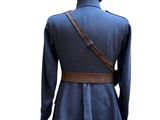 the back view of a blue jacket with a hood and a brown belt