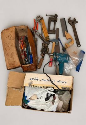 a box full of assorted tools sitting on a table