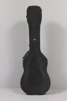 a black guitar case sitting on a white table