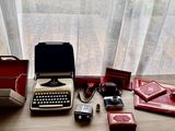 a typewriter sitting on a table next to a window