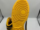 a close up of a pair of yellow shoes on a white surface