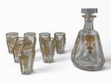 bottles and glasses are lined up on a white surface