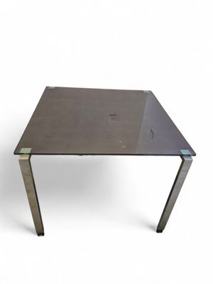 an image of a table with a glass top and metal legs