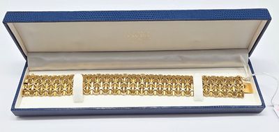 an image of a pair of gold bracelets in a blue box