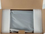 a cardboard box with a package in it on a white surface