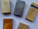 four different types of lighters sitting on a white surface