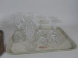 a tray with glasses and a bottle on it