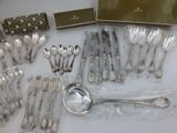 a lot of silver spoons and spoons on the table
