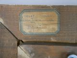 an old wooden box with a label on it