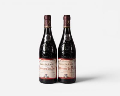 two bottles of red wine sitting next to each other on a white surface