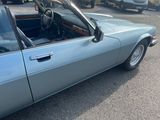 an image of a blue convertible car parked in a parking lot