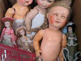 many dolls in a box that are sitting on a table