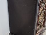 a black cabinet with carvings on it in a room