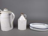 three pieces of white and blue pottery sitting next to each other