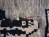 a close up of a sweater with a train on it