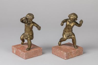 pair of bronze figurines of a boy and a girl on marble bases