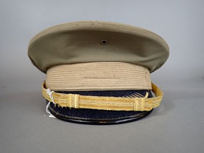 beige and blue hat with gold ribbon around the brim